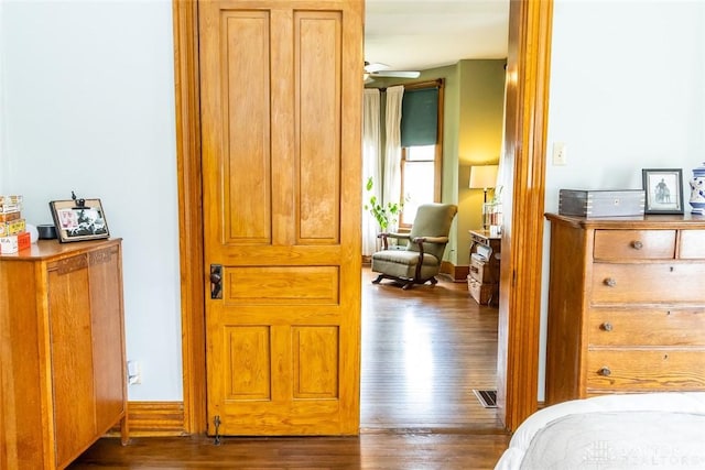 bedroom featuring baseboards and wood finished floors