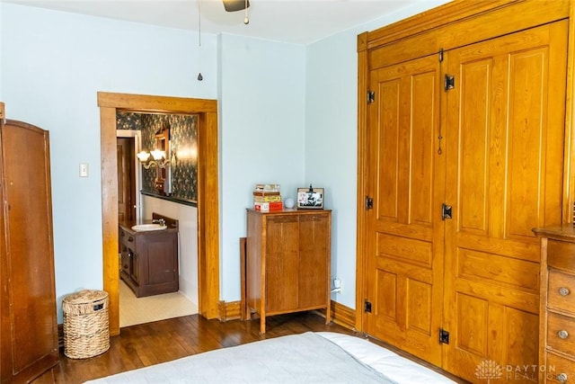 bedroom featuring baseboards and wood finished floors