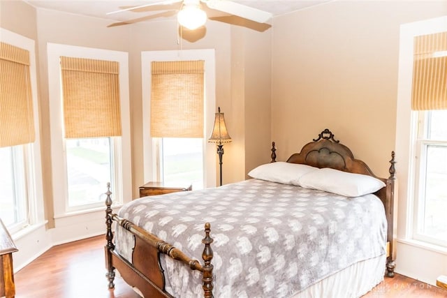 bedroom with ceiling fan and light wood-style floors