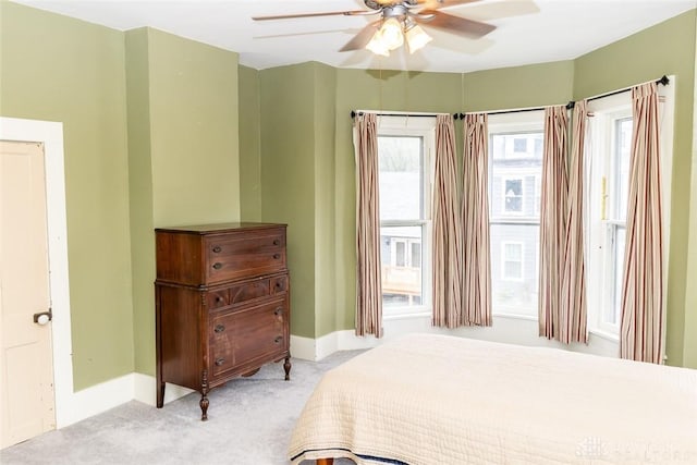 bedroom with ceiling fan, carpet, and baseboards