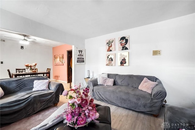 living room featuring ceiling fan and wood-type flooring