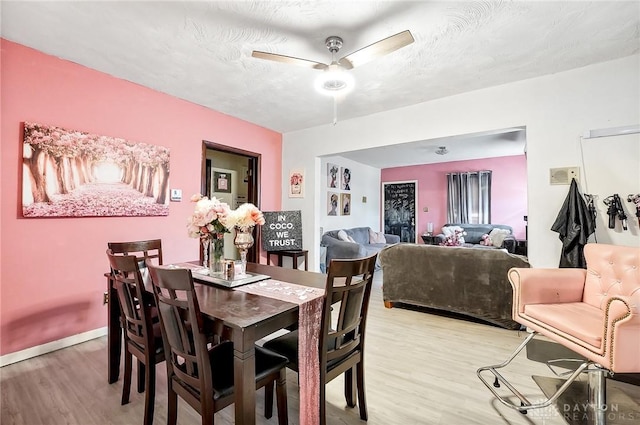 dining space featuring a textured ceiling, light hardwood / wood-style floors, and ceiling fan