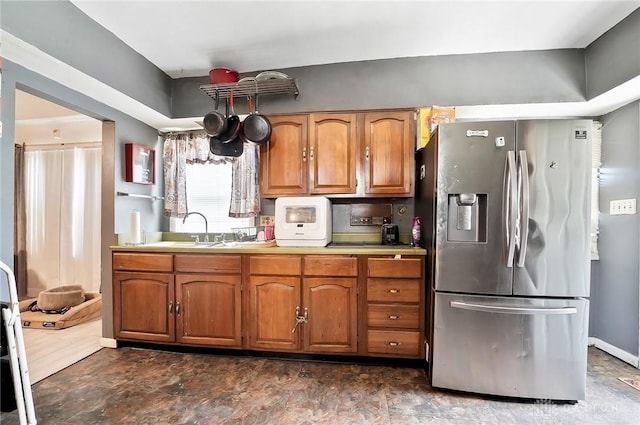 kitchen with stainless steel fridge with ice dispenser and sink