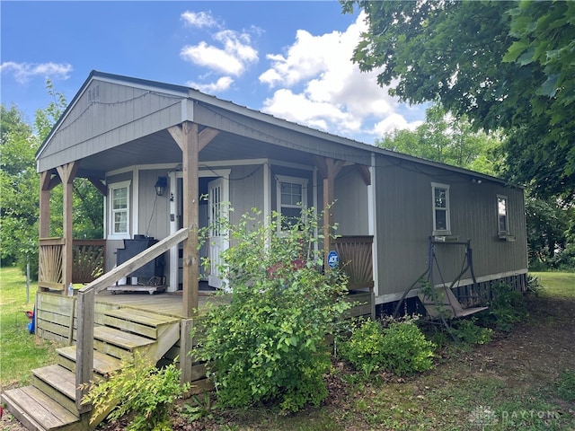 back of property featuring a porch