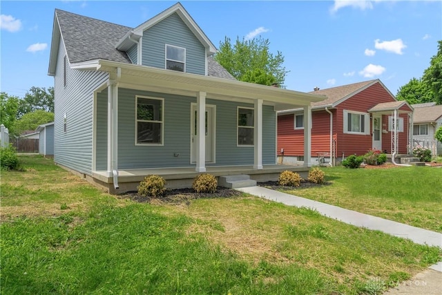 view of front of home featuring covered porch and a front lawn