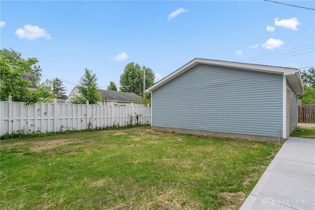 view of side of home featuring a yard and fence