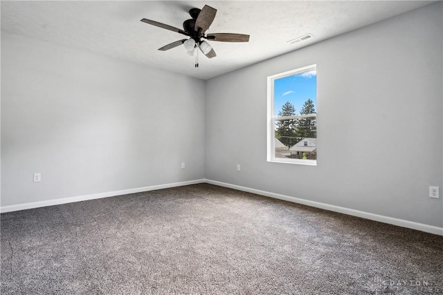 empty room featuring carpet floors, visible vents, baseboards, and a ceiling fan