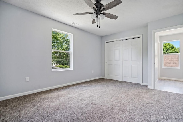 unfurnished bedroom with carpet floors, visible vents, and baseboards