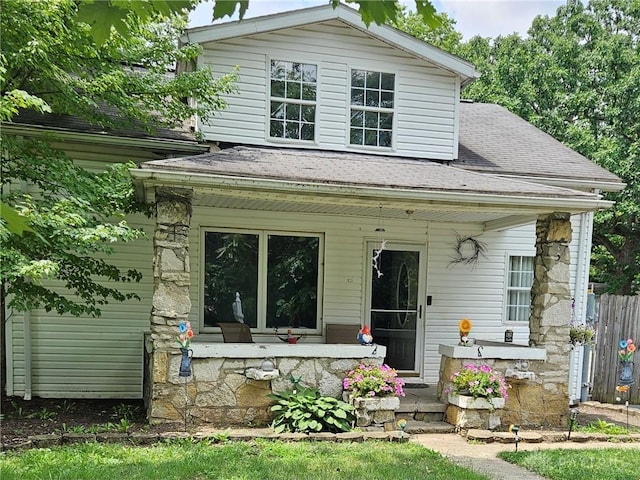 view of front of home with a shingled roof and a porch