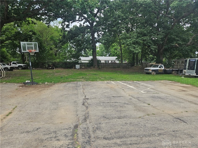 view of parking with a lawn