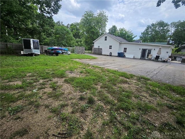 rear view of house featuring fence