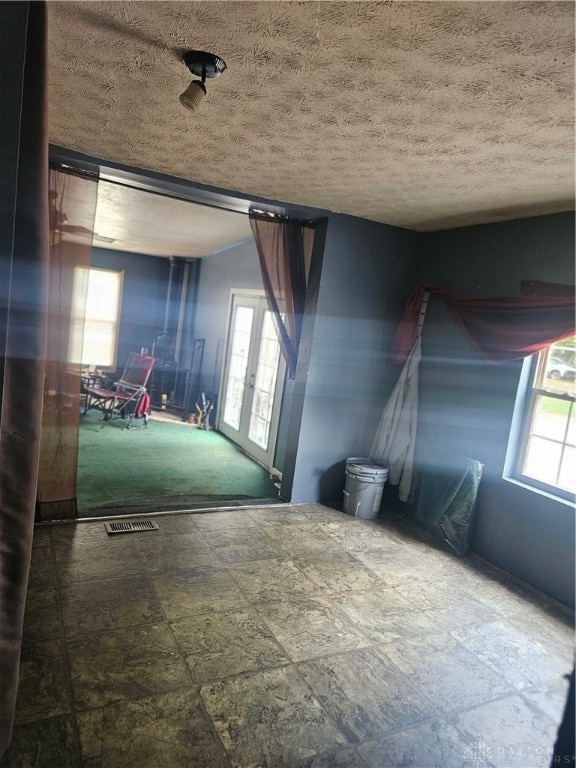 spare room featuring tile patterned floors and a textured ceiling