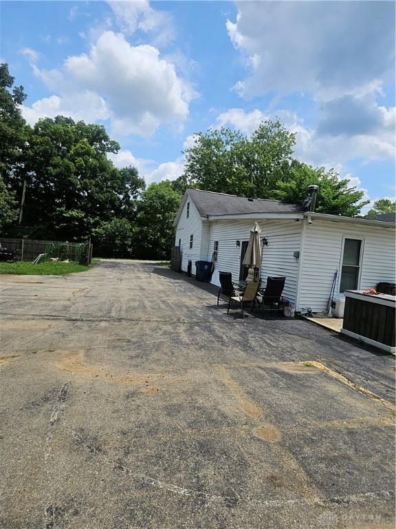 rear view of property featuring fence