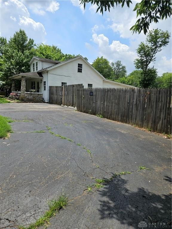 exterior space featuring fence and aphalt driveway