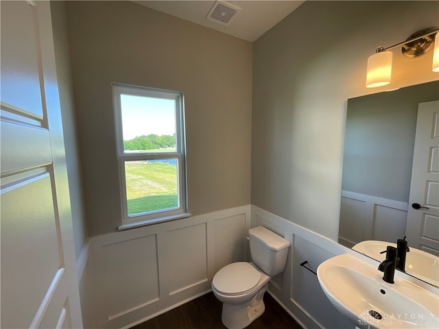 bathroom with sink, wood-type flooring, and toilet