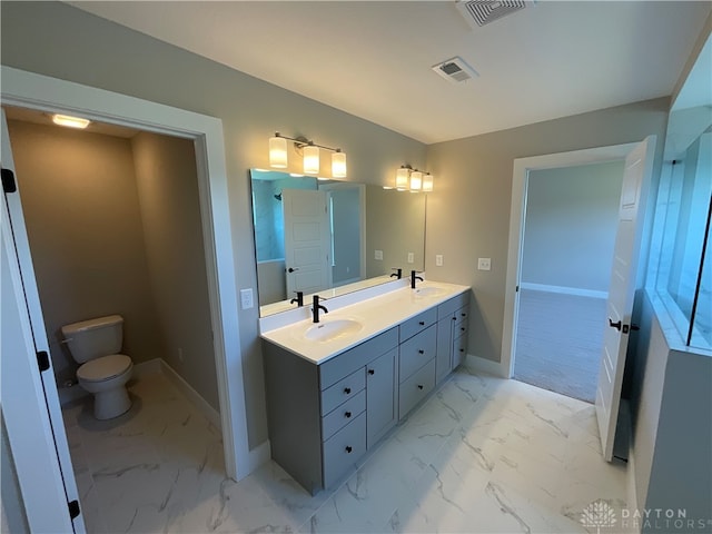 bathroom featuring vanity and toilet