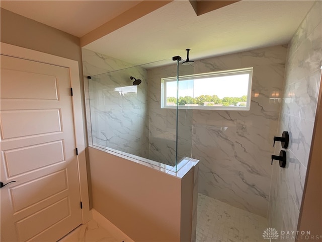 bathroom with a tile shower