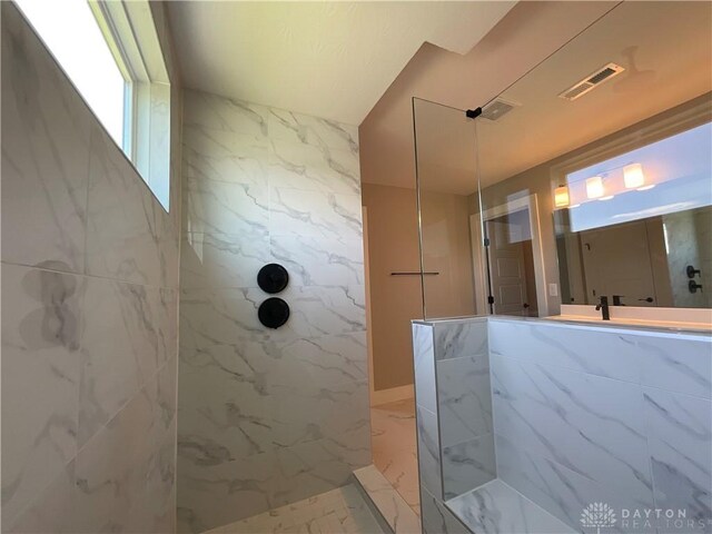 bathroom with tiled shower