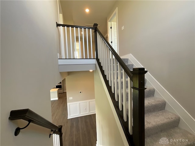 stairs featuring wood-type flooring