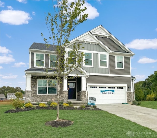 craftsman-style home featuring a front lawn and a garage