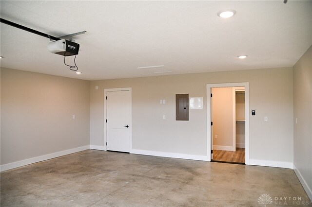 garage with a garage door opener and electric panel