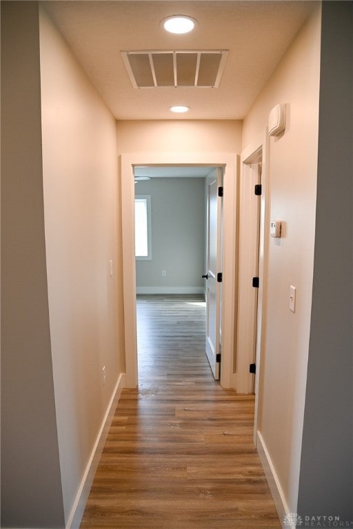 hallway with wood-type flooring