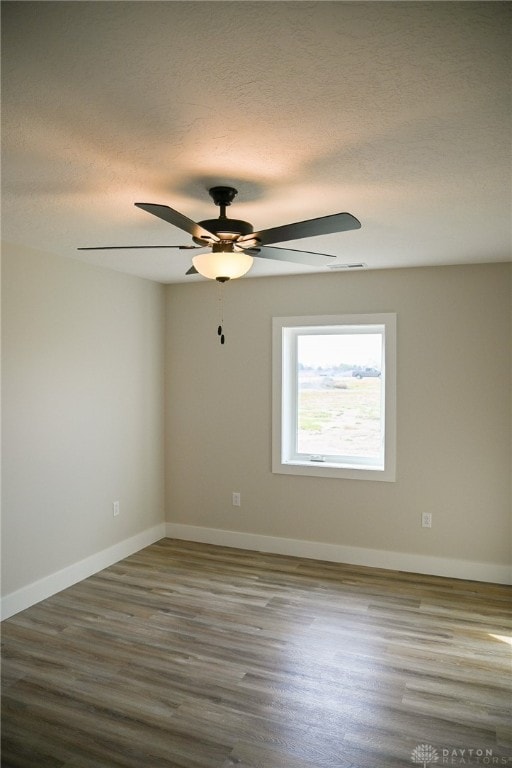 unfurnished room featuring a textured ceiling, hardwood / wood-style flooring, and ceiling fan