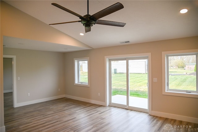 unfurnished room featuring lofted ceiling, light wood-type flooring, and ceiling fan