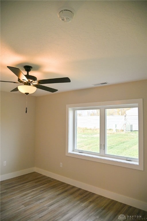 unfurnished room with hardwood / wood-style floors and ceiling fan