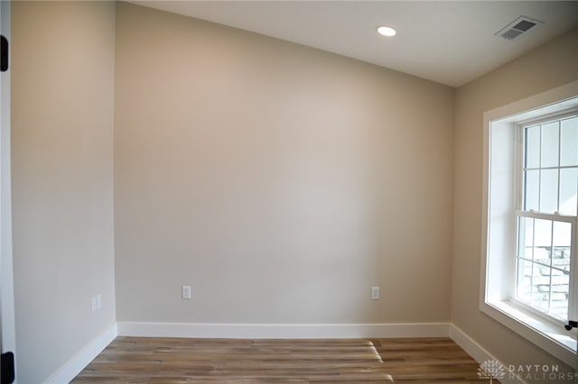 unfurnished room with wood-type flooring