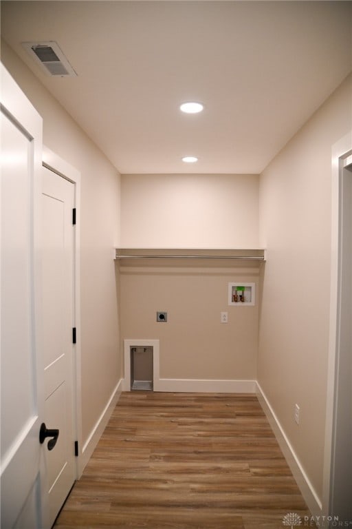 washroom with hookup for an electric dryer, hardwood / wood-style floors, and hookup for a washing machine