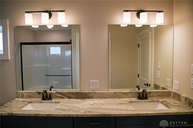 bathroom with vanity and a shower with shower door