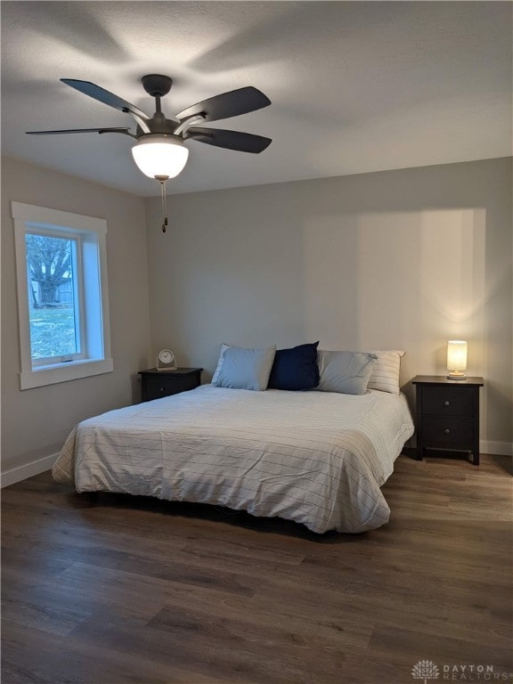 bedroom featuring dark wood-type flooring and ceiling fan