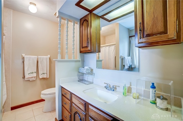 bathroom with vanity, tile patterned flooring, and toilet