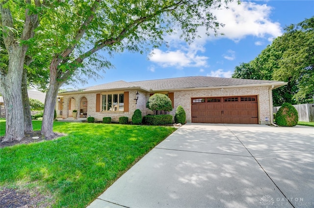 view of front of property featuring a garage and a front yard