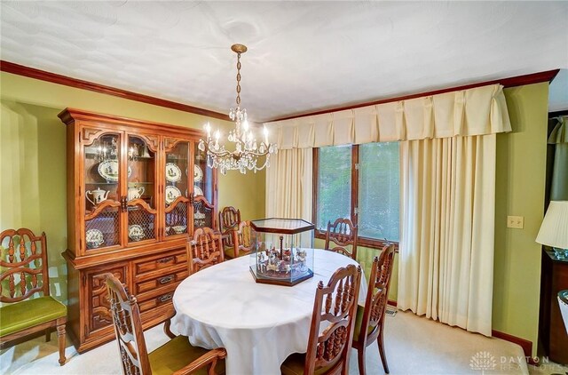 dining area with light carpet and a chandelier