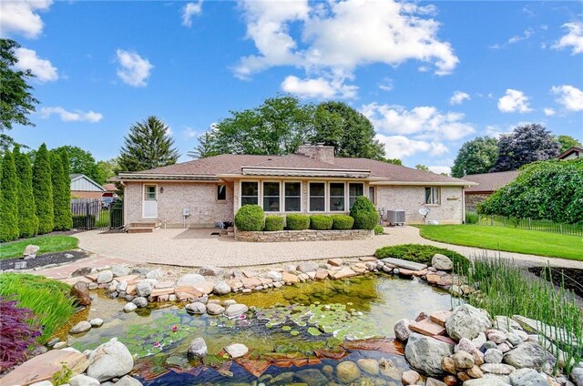 rear view of property with a patio and cooling unit