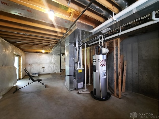 basement featuring water heater and heating unit