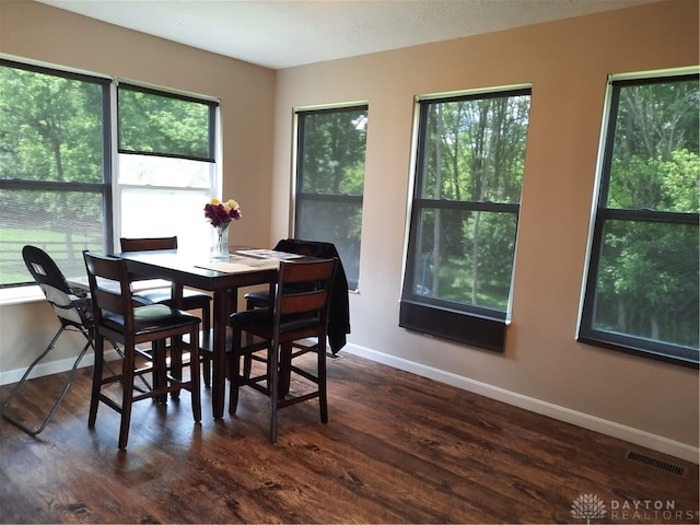 dining area with dark wood-type flooring