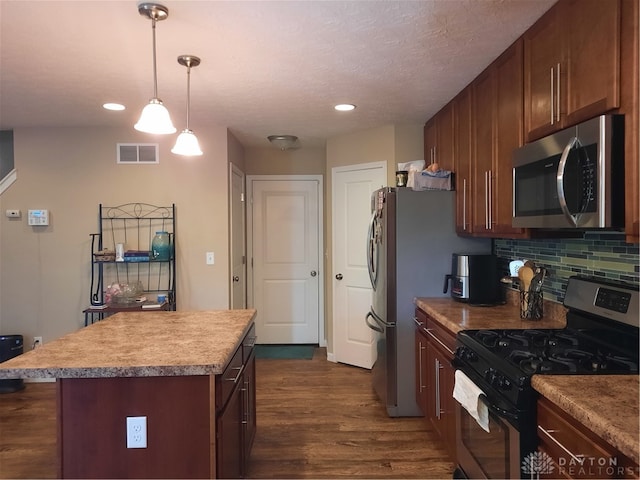 kitchen with a textured ceiling, dark wood-type flooring, black gas range oven, a kitchen island, and backsplash