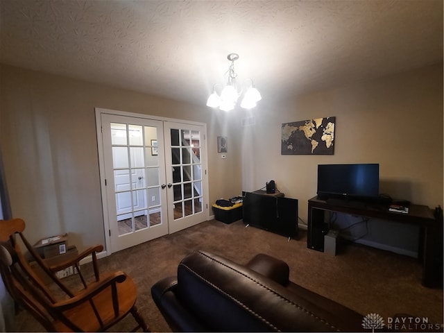 carpeted living room featuring french doors, an inviting chandelier, and a textured ceiling