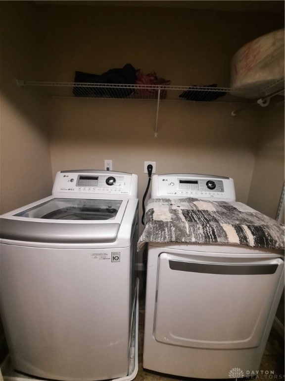 clothes washing area with independent washer and dryer