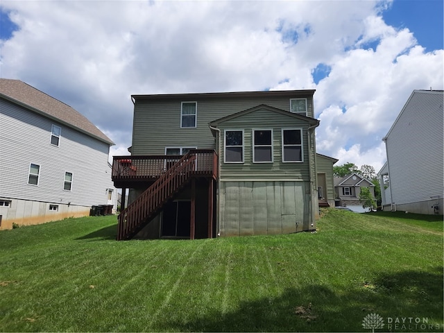 back of house featuring a yard and a wooden deck