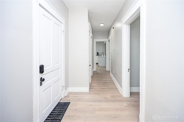 hall with light hardwood / wood-style flooring