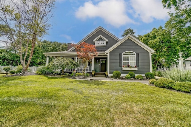 view of front of home featuring covered porch and a front yard