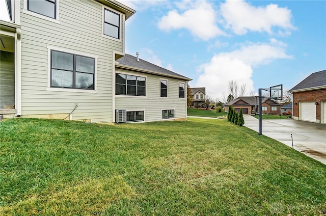 view of side of home with a lawn and a garage