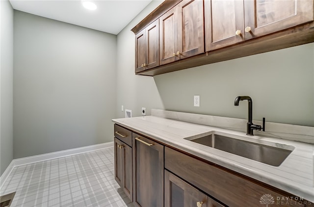 laundry area featuring cabinets, hookup for a washing machine, electric dryer hookup, and sink