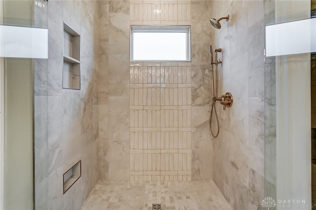 bathroom with tiled shower