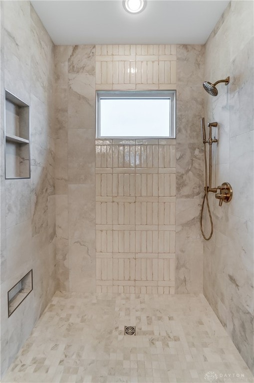 bathroom featuring a tile shower