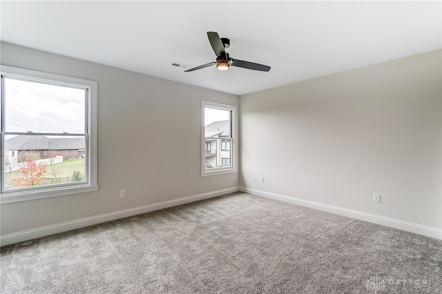 carpeted empty room featuring ceiling fan